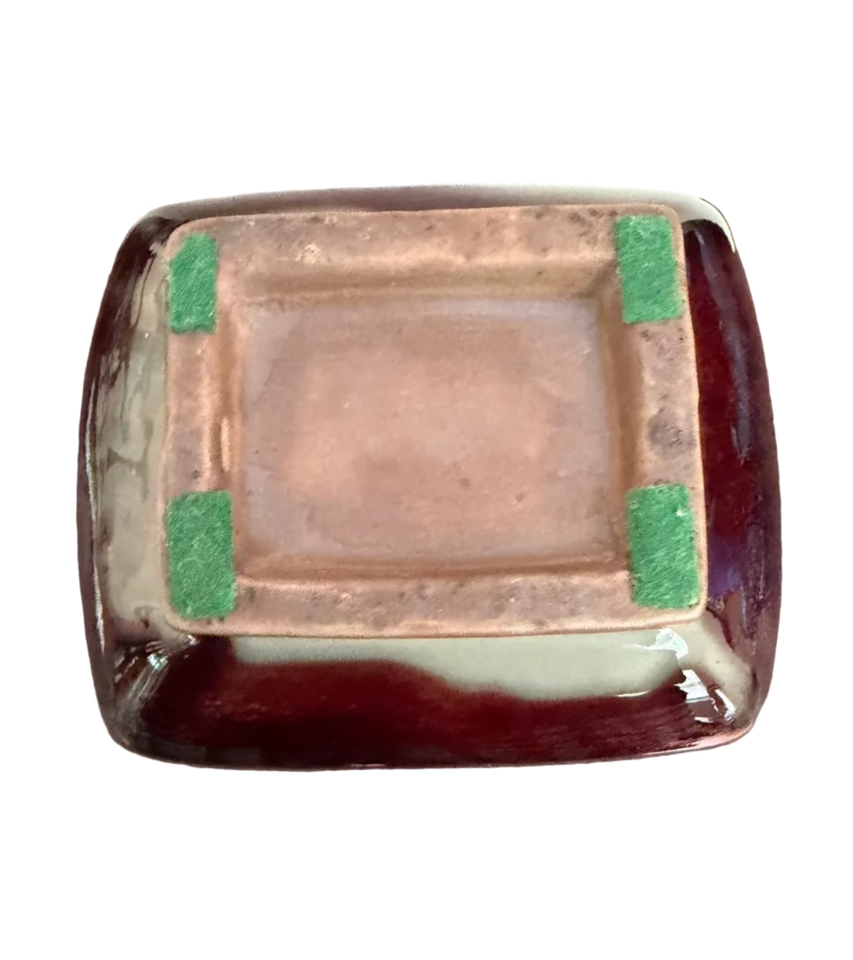 foot of a red vase with green accents 